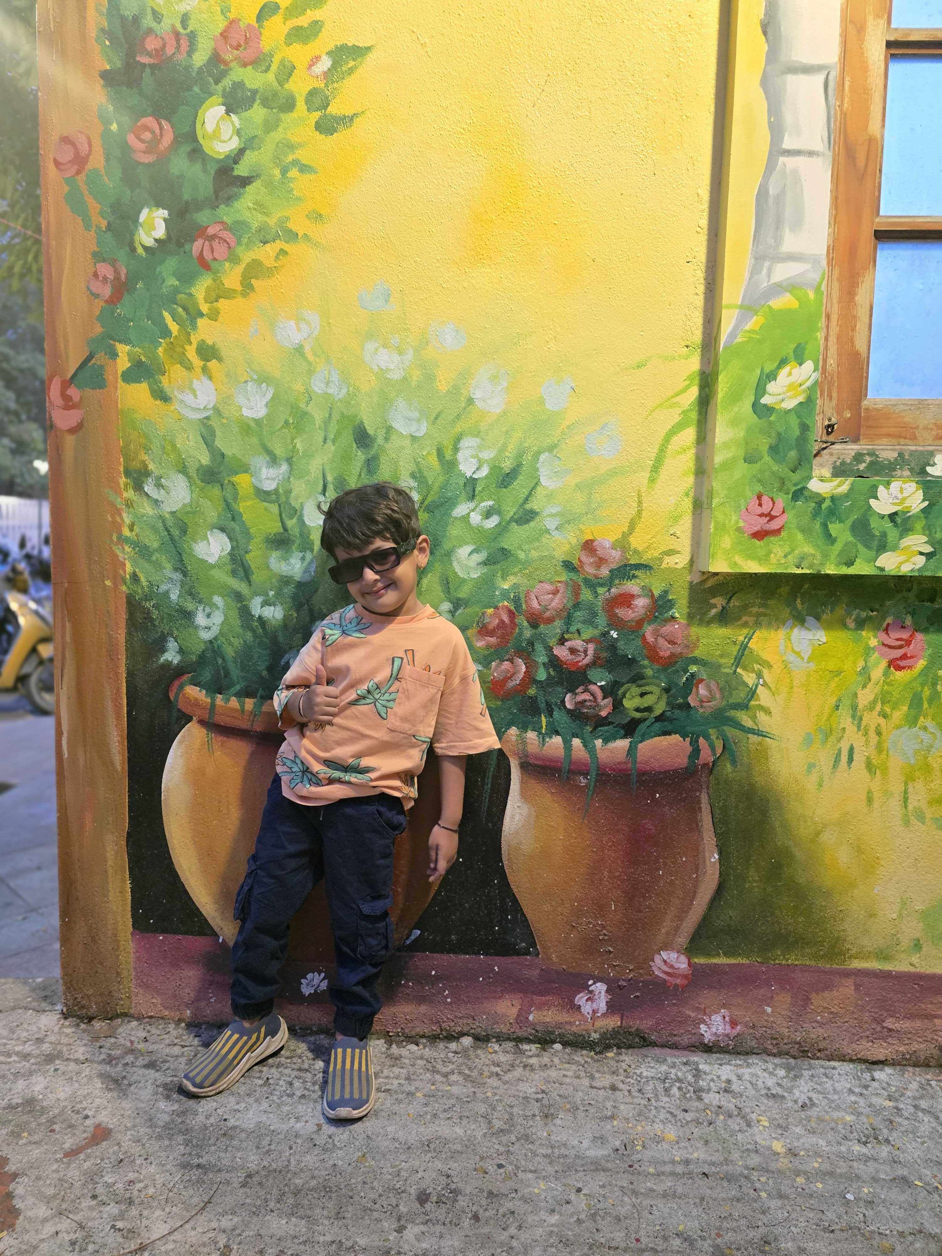 Akshar posing by a mural