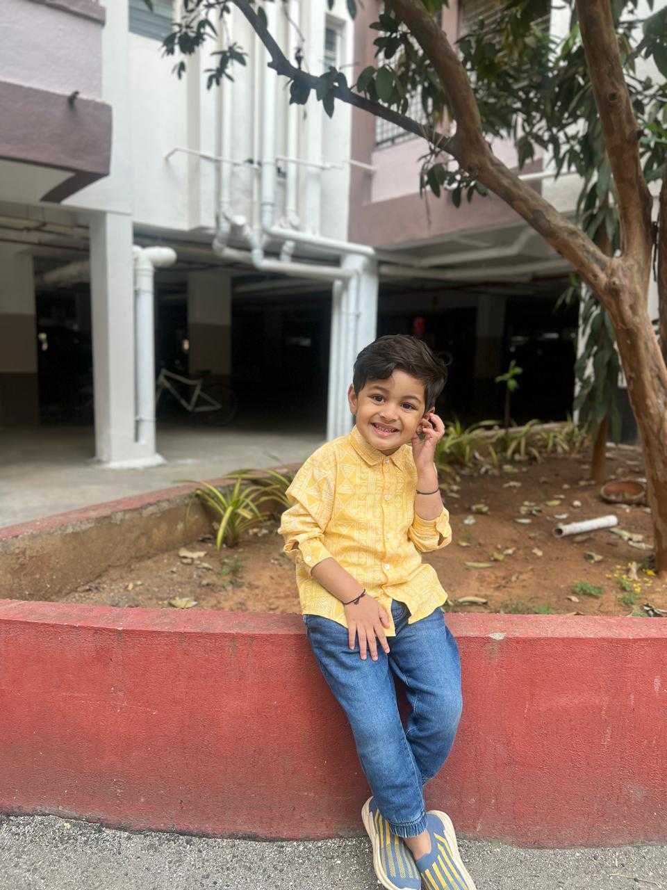 Akshar sitting with a smile